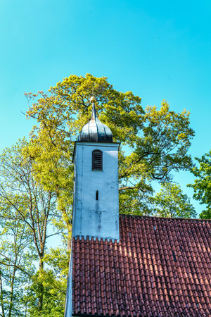 Church St. Clemens in Kranzberg near Freising, Bavaria in Germany with ancient graveyard and beautiful old wrought iron crossesの写真素材