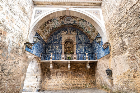 Porta da Vila is the main entrance to Obidos, Portugal. Double door with balcony. Interior lined or coated with blue and white tiles. Inside azulejosの写真素材