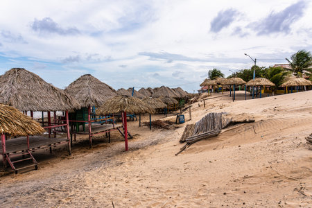 Colorful waters and natural-framed kiosks at Pesqueiro Beach, Soure in Marajo Island in Brazilの写真素材