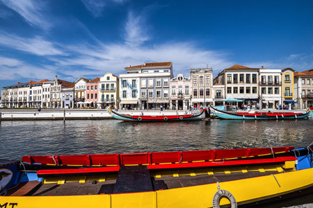 Aveiro, Portugal - Mar 18, 2025: Traditional boats on the canal in Aveiro, Portugal. Colorful Moliceiro boat rides in Aveiro are popular with tourists to enjoy views of the charming canals.のeditorial素材