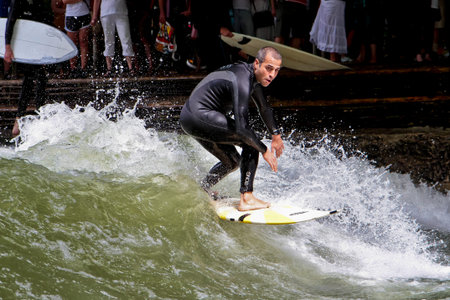 Munich, Germany - Jun 04, 2024: Surfer in the city river, Munich is famous for people surfing in...