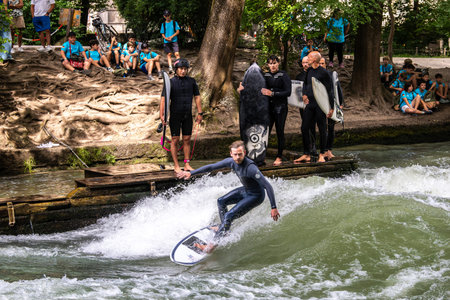 Munich, Germany - Jul 26, 2024: Surfer in the city river, Munich is famous for people surfing in...