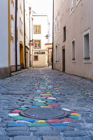 Passau, Germany - Apr 16, 2025: The very narrow, historic hell alley in the old town of Passau in Germany. Here the working craftsmen lived.のeditorial素材