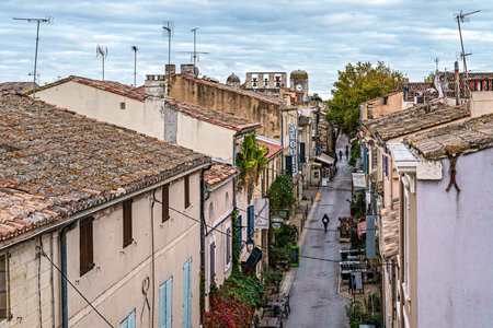 Aigues Mortes, France - Nov 05, 2025: The houses of the historic city center of Aigues-Mortes in France, Occitanie, Gard in Europe seen from above the medieval wallsのeditorial素材