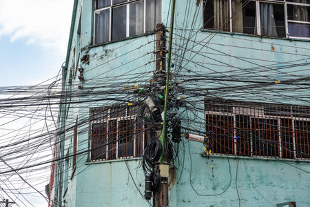Tangle of cables on electricity pylons. Cable clutter on an street power pole in Manaus, where...
