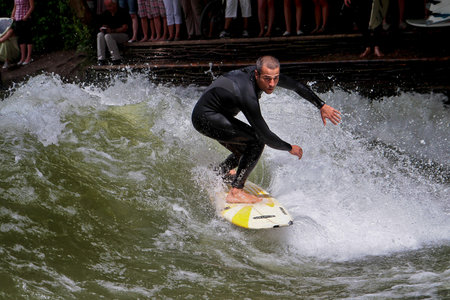 Munich, Germany - Jun 04, 2024: Surfer in the city river, Munich is famous for people surfing in...