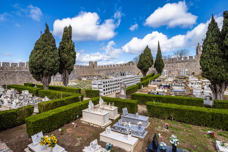 Santiago do Cacem, Portugal - Feb 26, 2026: Castle and Igreja Matriz cemetery in Santiago do Cacem,...
