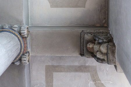 in a historical city of bavaria in south germany at summertime you see ornaments and candleholders and ceilings as well as benches and wall boards and door lock artworkの写真素材
