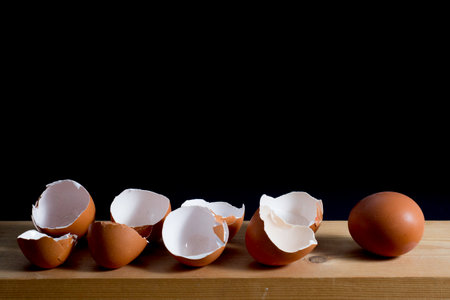 next egg to break - five eggs on table against black background