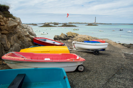 colorful Boats on the beach and Phare de l'Ile Vierge, Brittany, Franceの写真素材