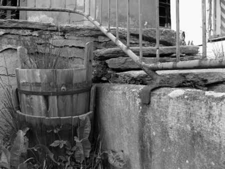 Courtyard with a bucket, wall and stairs in black and whiteの写真素材