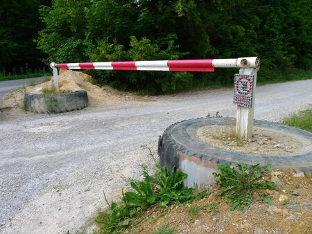 Red and white barrier across the road