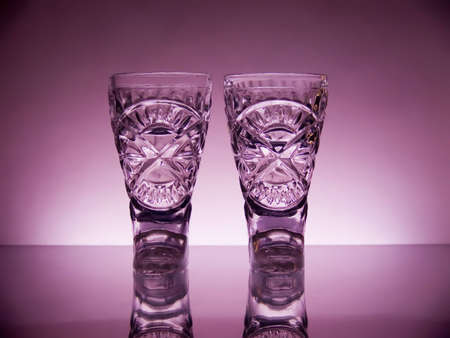 Two wine-glasses in the form of boots on a dark blue background.の写真素材