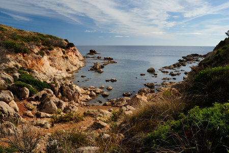View of Cala Greca beach at Capo Figariの写真素材
