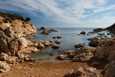 View of Cala Greca beach at Capo Figariの写真素材