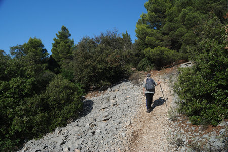 Hiking in the mountains. A woman walks along the trail on the Monte Tuttavista.の写真素材
