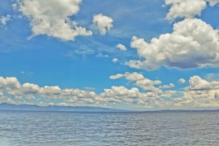 A fantastical photo of clouds over a seascape. の写真素材