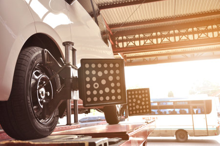 Car mechanics install sensors during wheel angle adjustment or spooring and balancing to the Wuling Air EV electric carのeditorial素材