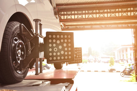 Car mechanics install sensors during wheel angle adjustment or spooring and balancing to the Wuling Air EV electric car