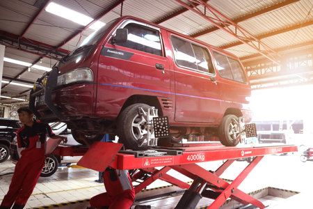 car wheel indoors service maintenance repair center against laser sensor equipment diagnostics and wheel alignmentのeditorial素材