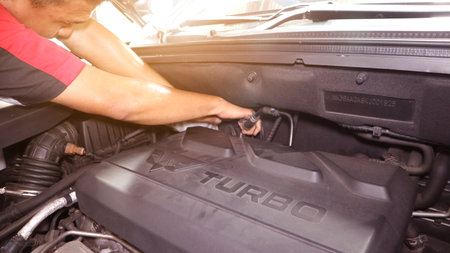 Car care maintenance and servicing, Close-up hand technician auto mechanic using the wrench to repairing change spare part car engine problem and insurance service support.のeditorial素材