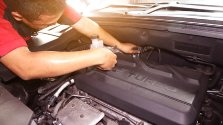 Car care maintenance and servicing, Close-up hand technician auto mechanic using the wrench to repairing change spare part car engine problem and insurance service supportのeditorial素材