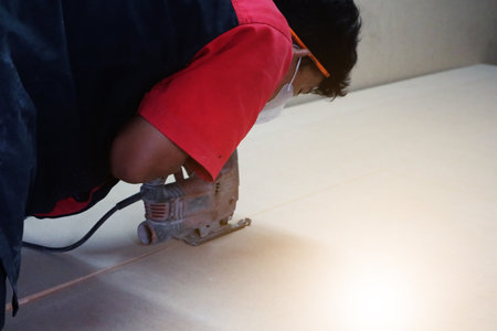 Male builder using wood cutting circular saw machine in workshopのeditorial素材