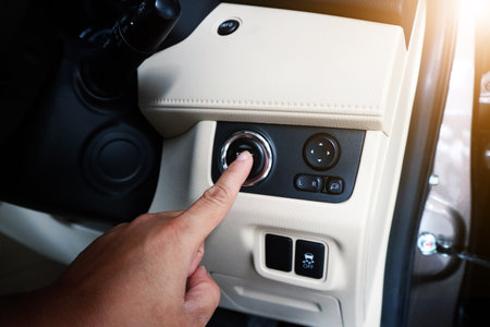 Car start stop system with finger pressing the button, horizontal imageのeditorial素材