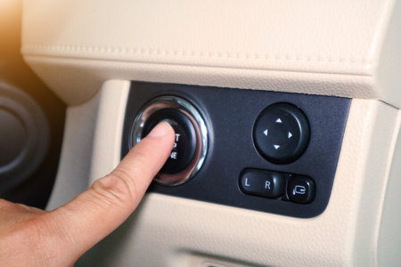 Car start stop system with finger pressing the button, horizontal imageのeditorial素材