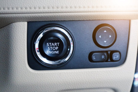 Car start stop system with finger pressing the button, horizontal imageのeditorial素材