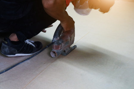 Male builder using wood cutting circular saw machine in workshopのeditorial素材