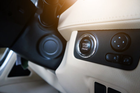 Car start stop system with finger pressing the button, horizontal imageのeditorial素材