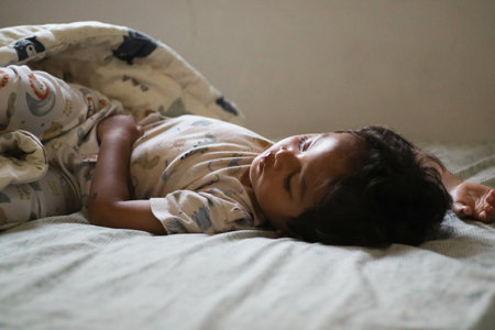 Adorable cute toddler or baby boy sleeping on bed at morning with sweet dream in bedroom Lovely child get deep sleep and get relax and happy during lying down on bed Little infant boy get good sleepの写真素材