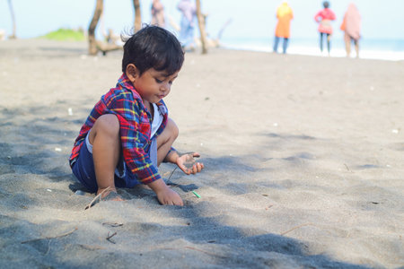 Happy kids have fun in sea surf on black sand beach. Children sit in seashore. Travel lifestyle, swimming activities in family summer camp. Vacations on tropical island.の写真素材