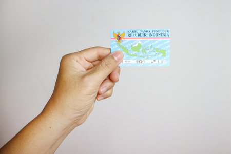 hand holding Indonesian identity cards or E-KTP ( Kartu Tanda Penduduk ) owned by Indonesian citizensの写真素材