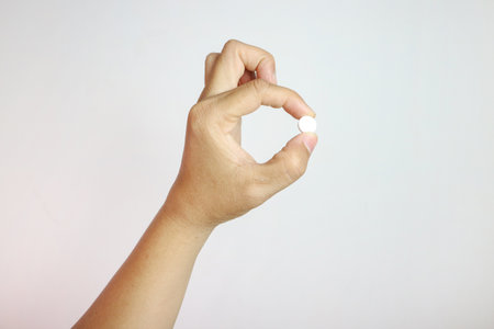 Pill of painkiller in doctor hand. Pharmacy, medicine concept.の写真素材