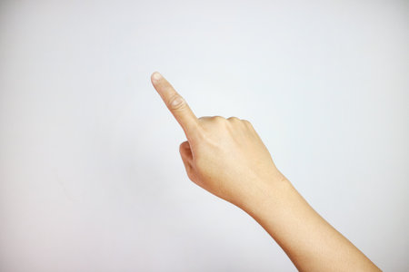 young man hand pointing isolated finger on white background.の写真素材