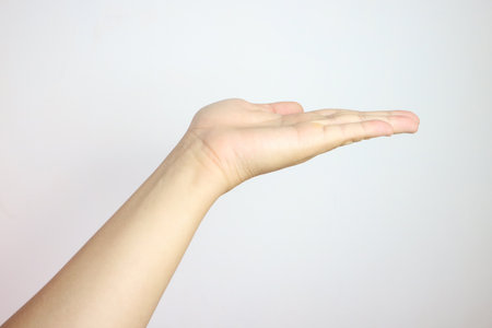 Hand palm open stretching reach outstretched. Empty give hold white gesture isolated. Help background, male body person people human concept. Man mature expressing expressionの写真素材