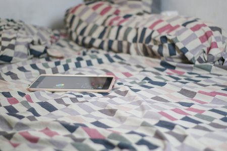 Tablet is on the mattress after being used by the child.