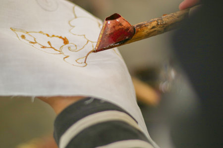 A woman is making batik. Batik is a traditional Indonesian cloth which is the ancestral heritage of the Indonesian peopleの写真素材