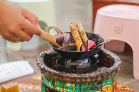 waxing process of batik painting using brush and malamの写真素材