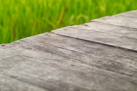 Wooden table on rice field and cloud background. For your product placement or montage with focus to the table top in the foreground. Empty wooden brown shelf. shelvesの写真素材