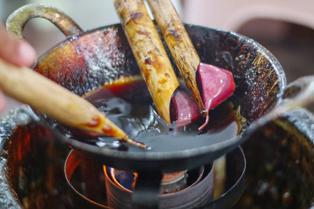 Canting and Batik wax liquid to make batik, traditional Indonesia fabric. Canting is kind of pen to draw for batikの写真素材