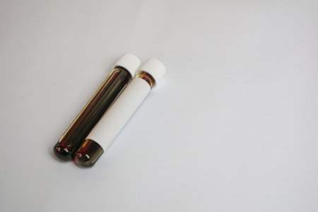 Blood in test tube with blank label on white background. Medical analysisの写真素材