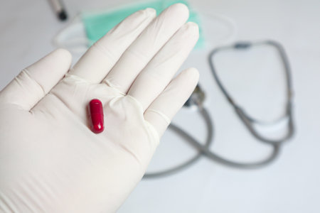 Elderly sick ill woman hold two pills on hand pouring capsules from medication bottle take painkiller supplement medicine, old senior people pharmaceutical healthcare treatment concept, close up viewの写真素材