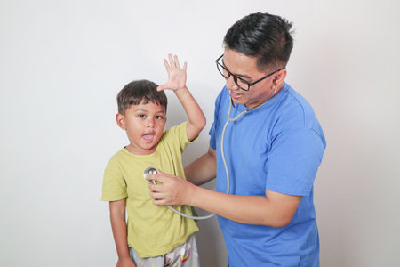 portrait of a baby being checked by a doctor using a stethoscopeの写真素材
