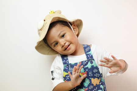 Happy of Asian little boy waving hand on white background.の写真素材