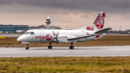 Warsaw Frederic Chopin International Airport / Poland - Dec.03.2019: SP-KPO Sprintair Saab 340 Airplaneのeditorial素材
