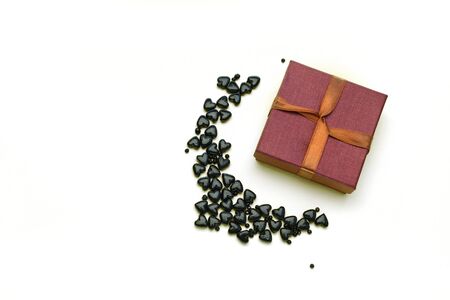 Small gift box with black hearts isolated on white backgroundの写真素材