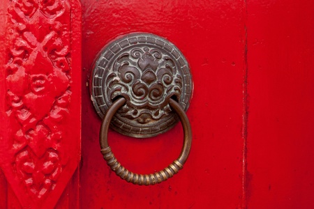 Old rusty gate latch on the red door の写真素材